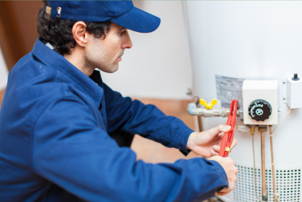 A serviceman working on a water heater