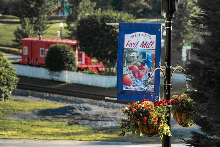 Park, trees, and train with sign in Fort Mill, South Carolina. 