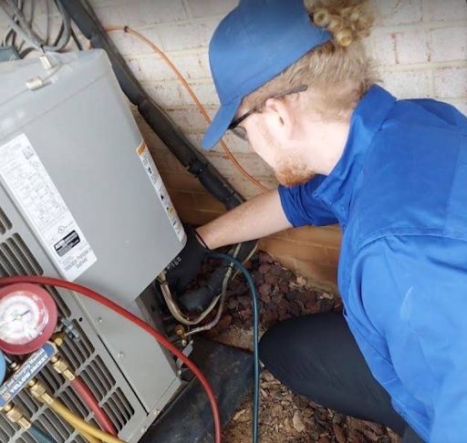 Brothers Air HVAC tech repairing heater. 