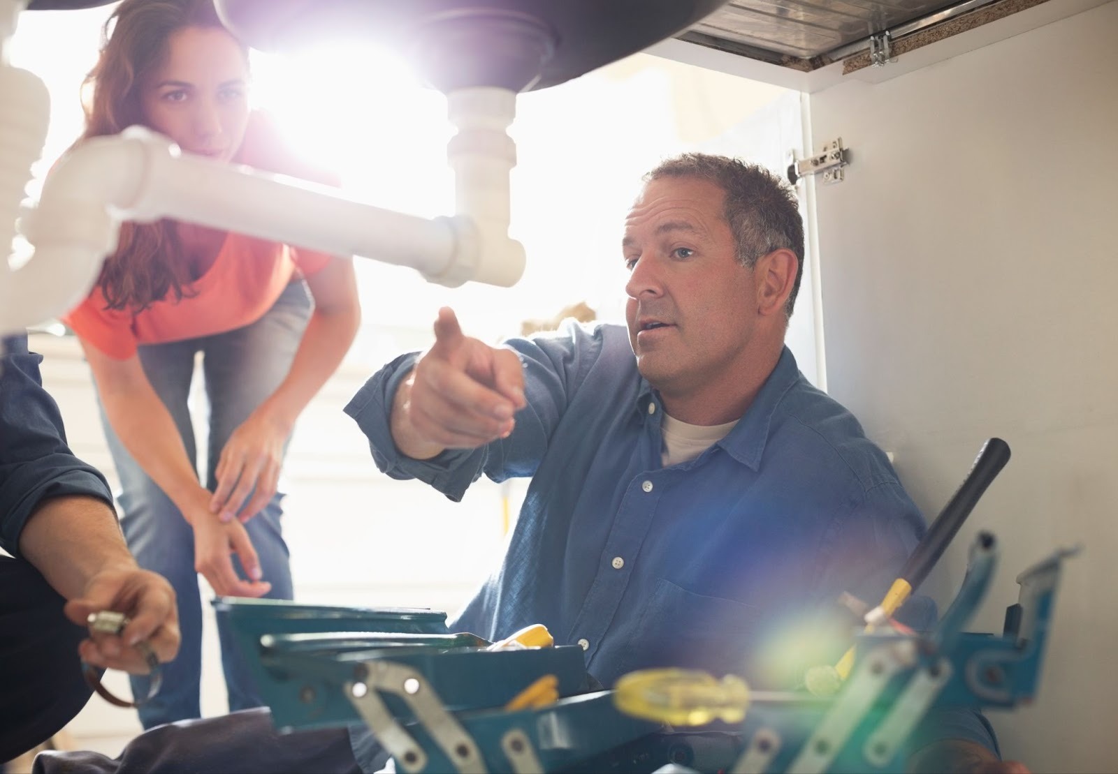 A plumber explains his work to a homeowner
